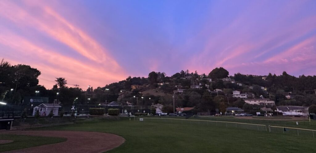 Photo of a sunset with pink clouds over the Strawberry Recreation District field