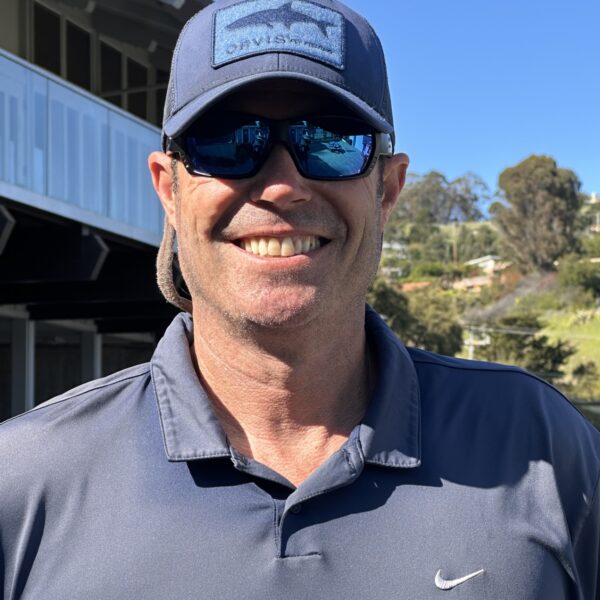 Male tennis pro, Keith Pollak, in blue cap